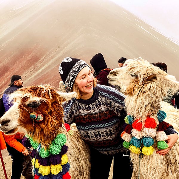 Participant with two alpacas in her arms